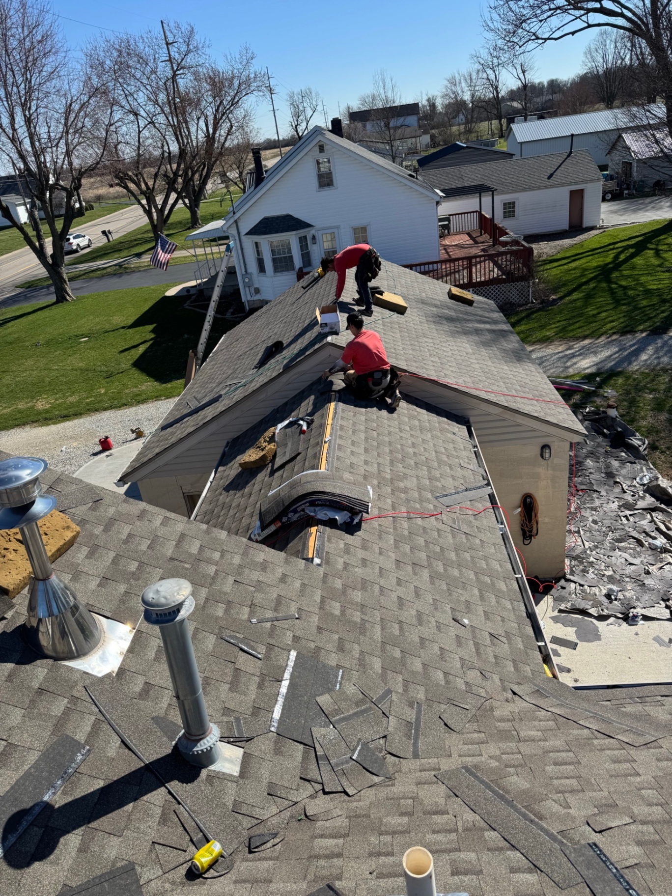 Tear-off — Crew stripping old shingles