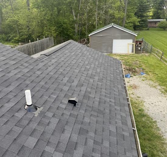 The same slope finished with charcoal architectural shingles