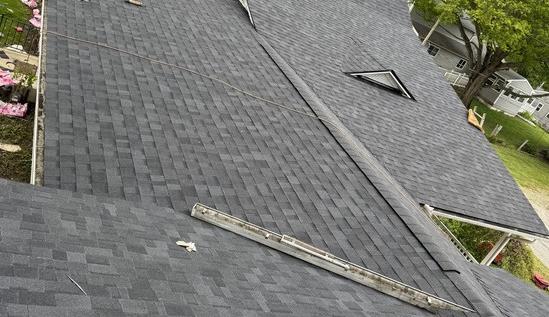 Charcoal architectural shingle roof after a full tear-off and replacement