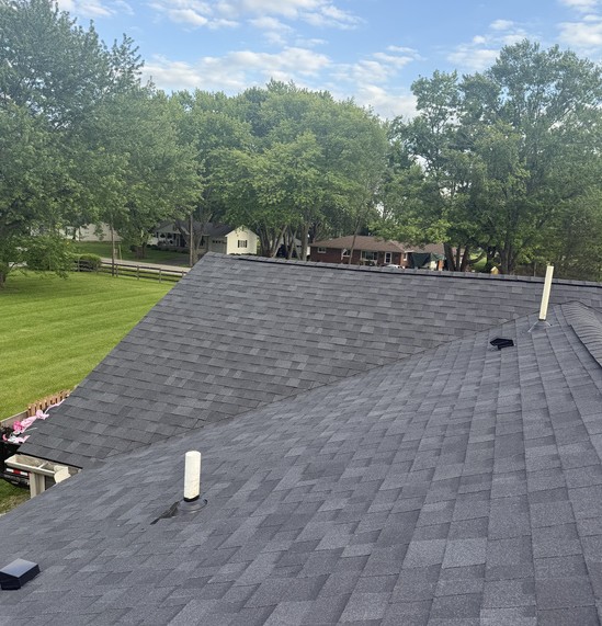 Wide view of a finished architectural shingle roof and pipe boot